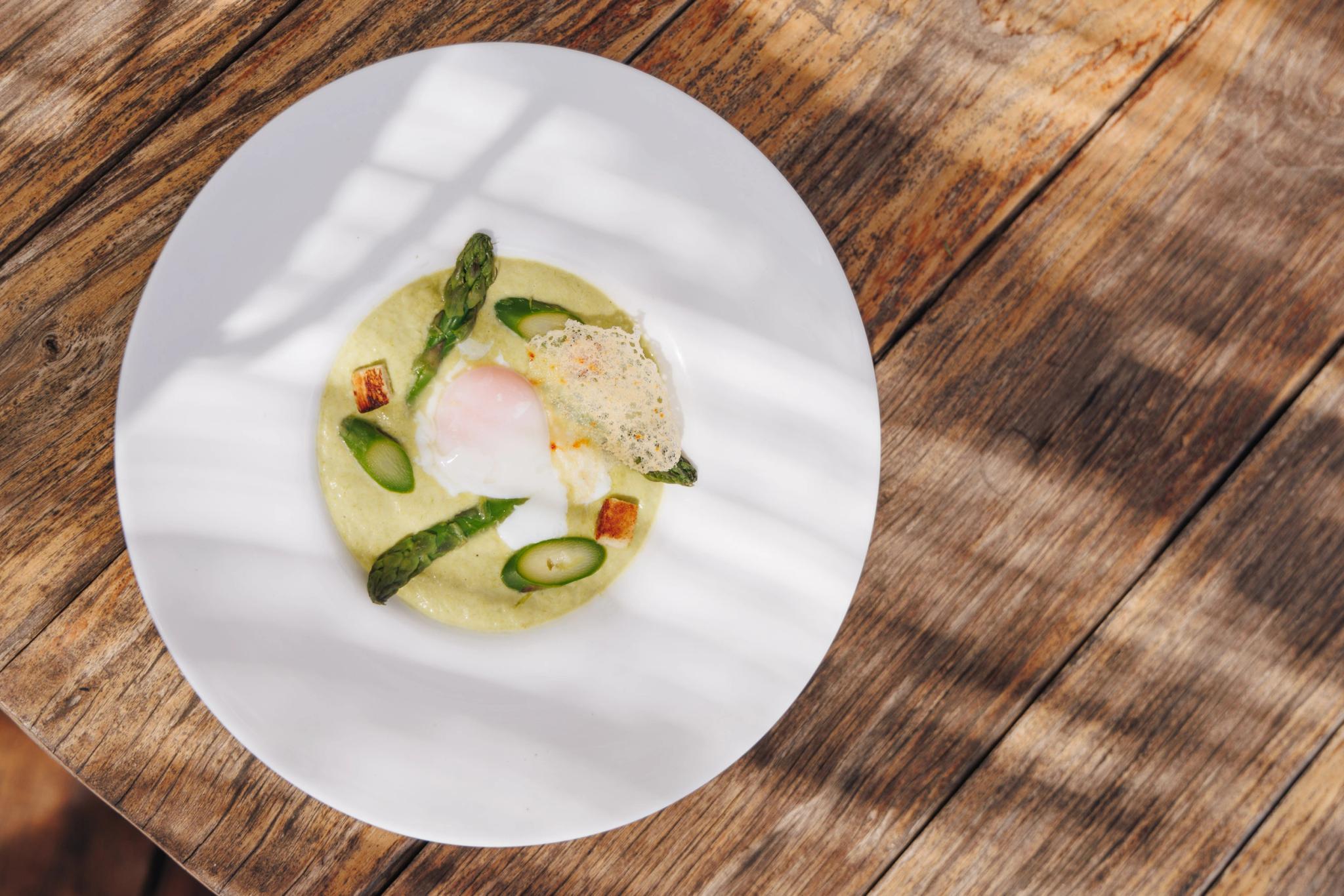 Assiette gastronomique de restaurant corse avec œuf poché et asperges