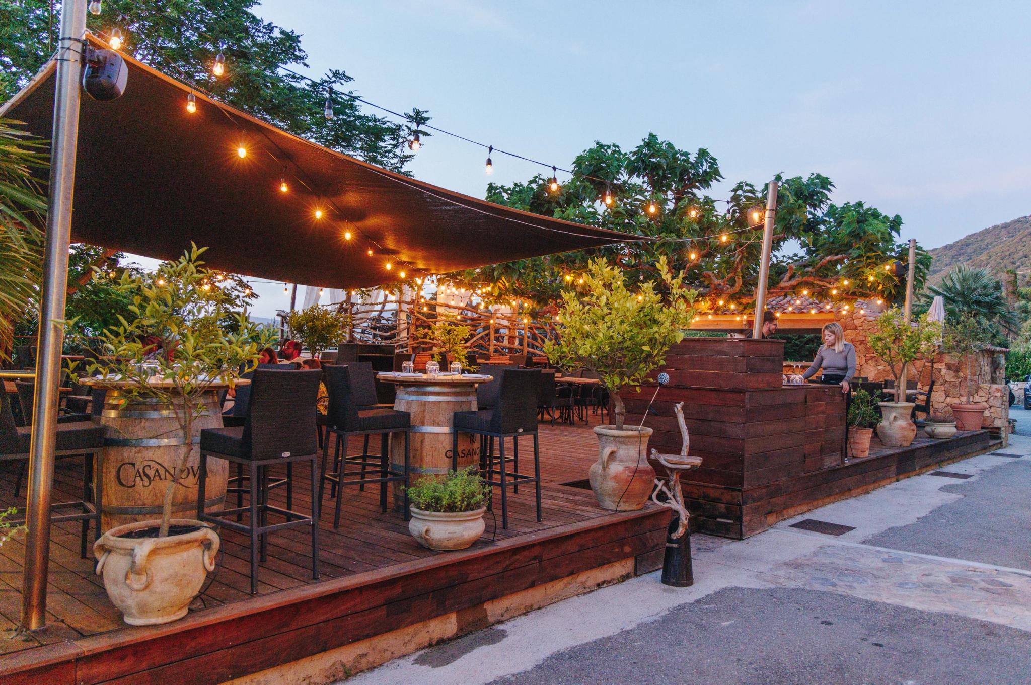 Restaurant en Corse avec terrasse illuminée et décoration rustique en bois